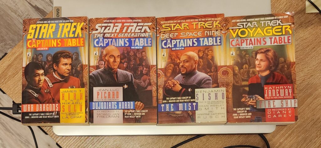 The covers of the first four Captain's Table books, placed sequentially from left to right to form one extended mural.