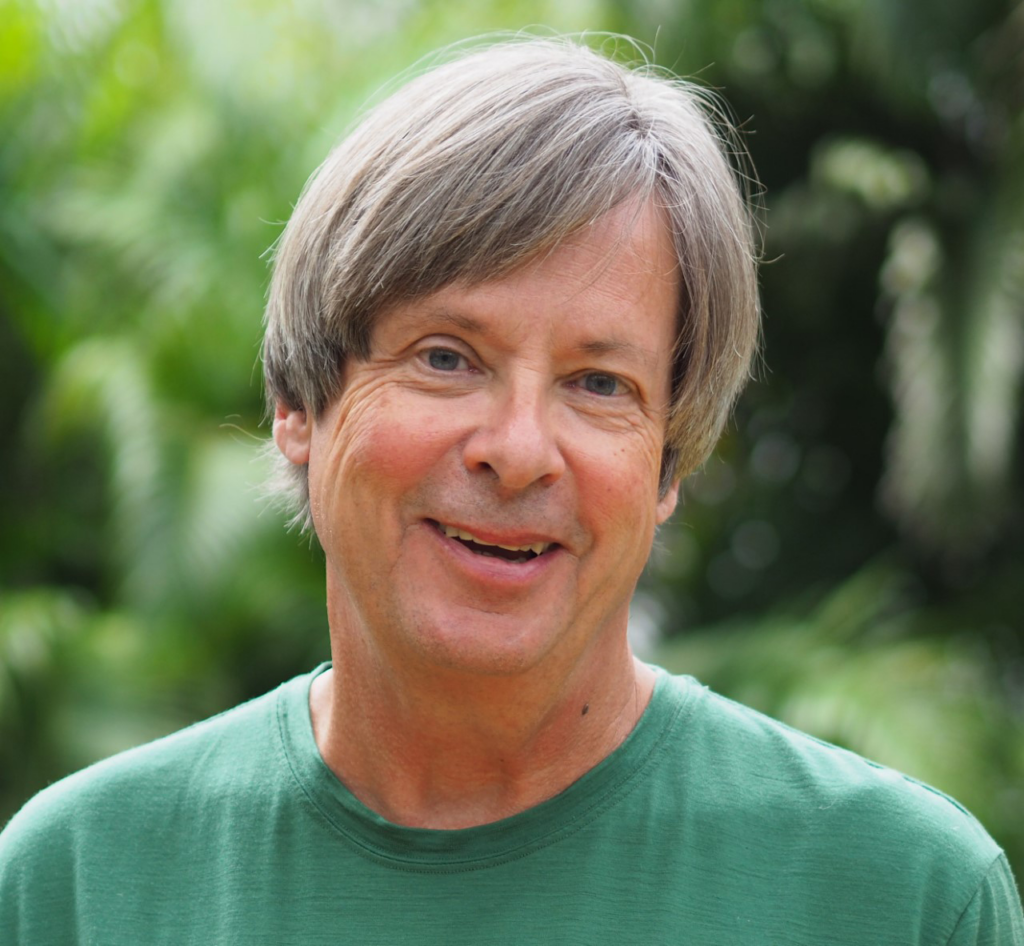 Newspaper columnist Dave Barry, smiling and wearing a plain green T-shirt.